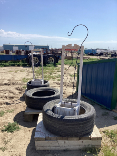 WOOD PLANTER W/ SHEPARDS HOOKS AND 3 TIRE FEEDERS MOUNTED ON PALLETS