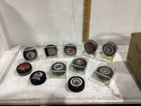 A COLLECTION OF HOCKEY PUCKS - SOME ARE SIGNED