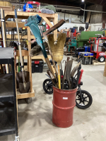 GARBAGE CAN W/WATERING WAND, BROOMS, RAKES, POST HOLE DIGGER