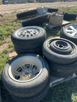 Pallet of eight car tires on rims