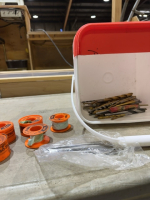 Partial bucket of drillbits and Plumber tape