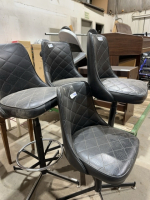 Four black leather barstools