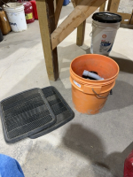 Pail of PVC elbows and rubber floor mats