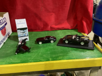 2 MODEL CARS AND A CELL PHONE HOLDER