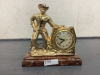 ELECTRIC "COWBOY" CLOCK ON PLASTIC BASE - BRASS COLORED METAL