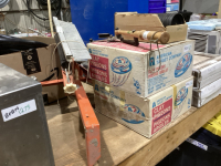 2 FULL BOXES OF CLAY PIGEONS, HAND HELD THROWER, AUTOMATIC FLINGER